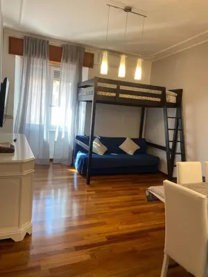 a room with a bunk bed and a desk at Appio11 Apartment in Rome