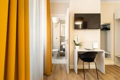a room with a table and a yellow curtain at AlbaDea Deluxe in Rome
