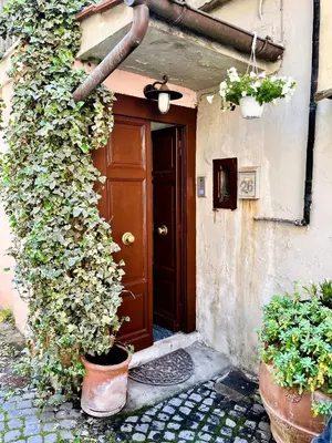 an entrance to a house with a door and plants at GuestHost - Flaminio MM Comfy Loft - Piazza del Popolo in Rome