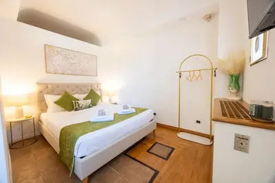 a bedroom with a bed with two towels on it at MB SUITES Margutta in Rome