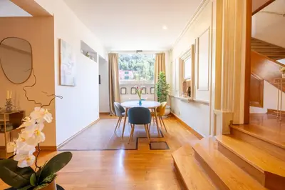 a dining room with a table and chairs and a window at MB SUITES Margutta in Rome
