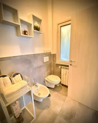 a bathroom with a toilet and a sink at I-LARI Apartment in Rome