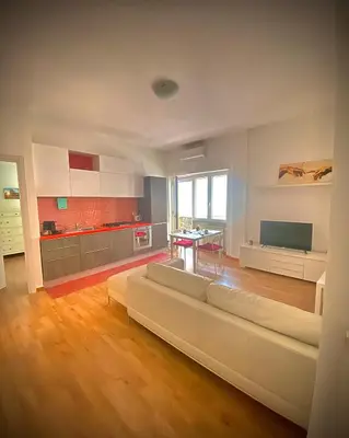 a large living room with a couch and a table at I-LARI Apartment in Rome