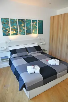 a bedroom with a large bed with towels on it at Roma Clodio Holiday in Rome
