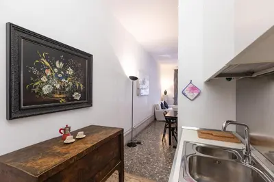 a kitchen with a sink and a painting on the wall at Angelico By Rental in Rome in Rome