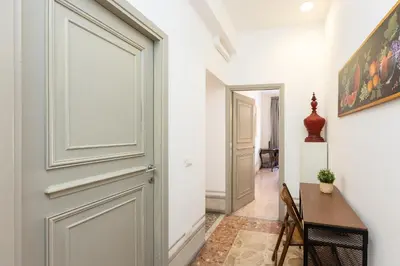 a door leading into a hallway with a table and a desk at Angelico By Rental in Rome in Rome
