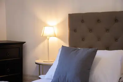a bedroom with a bed and a lamp on a table at Angelico By Rental in Rome in Rome