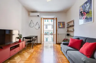 a living room with a couch and a flat screen tv at AM House Colosseo in Rome