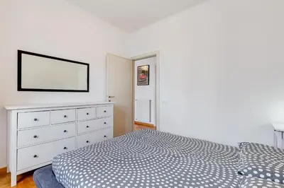 a bedroom with a bed and a dresser with a tv at AM House Colosseo in Rome