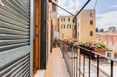a balcony of a building with flowers on it at AM House Colosseo in Rome