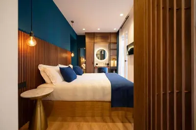 a bedroom with a bed and a blue wall at Palazzetto Symphony in Rome