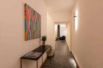 a hallway with a table and a painting on the wall at Palazzetto Symphony in Rome