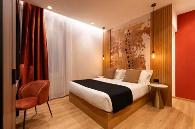 a hotel room with a bed and a chair at Palazzetto Symphony in Rome