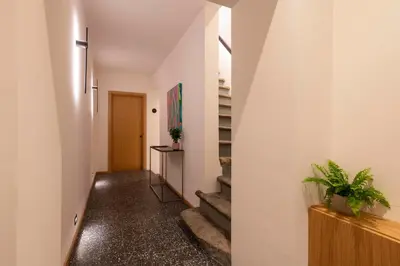 a hallway of a house with stairs and plants at Palazzetto Symphony in Rome