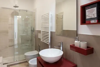 a bathroom with a sink and a toilet and a shower at Designer Apartment Via Nazionale in Rome