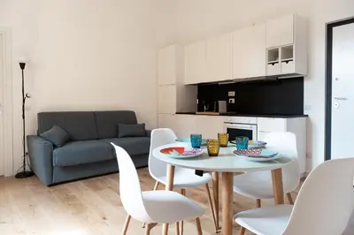 a living room with a table and chairs and a couch at Designer Apartment Via Nazionale in Rome