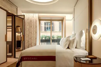 a living room with a white couch and a table at Bvlgari Hotel Roma in Rome