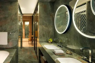 a bathroom with a tub and a plant in it at Bvlgari Hotel Roma in Rome