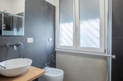 a bathroom with a white sink and a mirror at Venturi Comfort in Rome