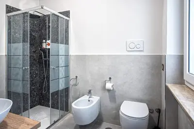 a bathroom with a toilet and a shower and a sink at Venturi Comfort in Rome