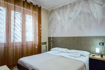 a bedroom with a bed with two towels on it at Venturi Comfort in Rome