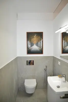 a bathroom with a white toilet and a sink at Fidia Palace Claudia's apartment Colosseo in Rome