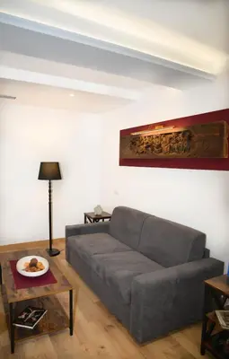 a living room with a couch and a table at Fidia Palace Claudia's apartment Colosseo in Rome