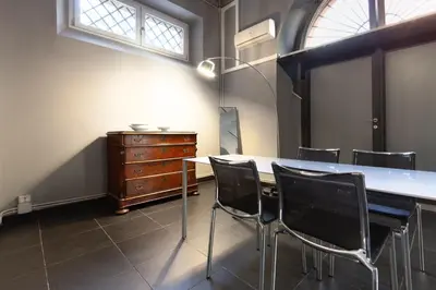 a room with a table and chairs and a dresser at Trastevere Loft in Rome