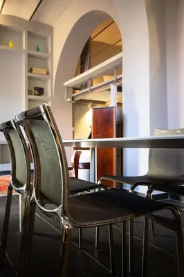 four chairs sitting at a table in a room at Trastevere Loft in Rome