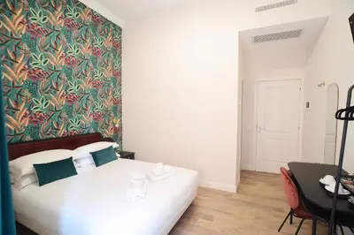 a bedroom with a white bed and a colorful wall at San Cosimato 40 guesthouse in Rome