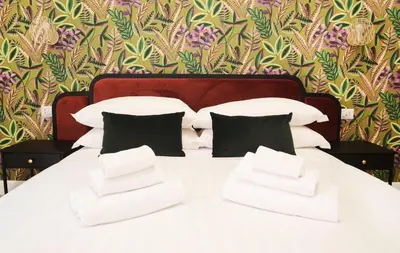 a white bed with black pillows in a bedroom at San Cosimato 40 guesthouse in Rome