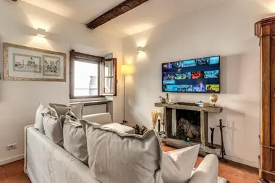 a living room with a couch and a fireplace at MAYA RHOME TRASTEVERE in Rome