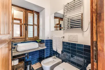 a bathroom with a toilet and a sink at MAYA RHOME TRASTEVERE in Rome