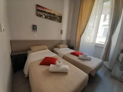 a room with three beds with towels on them at GUEST HOUSE FIDARDO in Rome