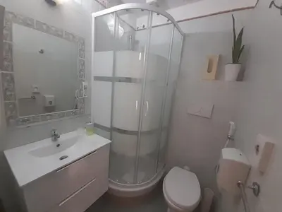 a bathroom with a shower and a toilet and a sink at GUEST HOUSE FIDARDO in Rome