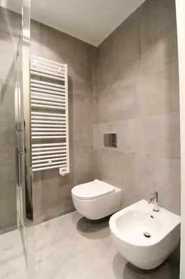 a bathroom with a toilet and a sink at HT Luxury Altare della Patria in Rome