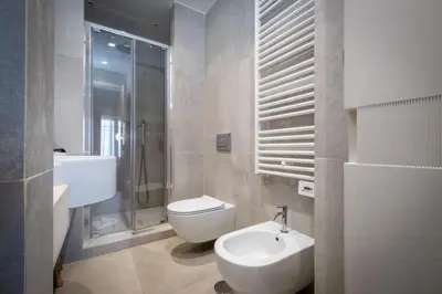 a bathroom with a toilet and a sink and a shower at HT Luxury Altare della Patria in Rome