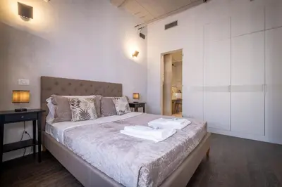 a bedroom with a bed with two towels on it at HT Luxury Altare della Patria in Rome