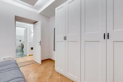 a living room with white cabinets and a couch at Spanish Steps Suite - Zucchelli in Rome