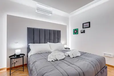 a bedroom with two dogs laying on a bed at Spanish Steps Suite - Zucchelli in Rome