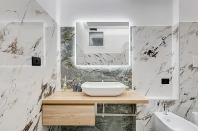 a bathroom with a sink and a mirror at Spanish Steps Suite - Zucchelli in Rome