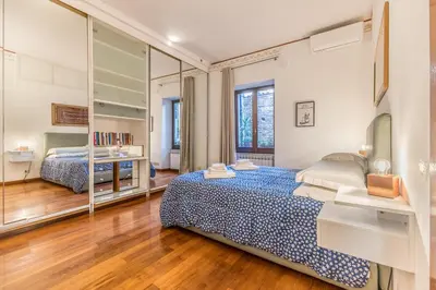 a bedroom with a large bed and a mirror at Casa Ghetto 13 in Rome