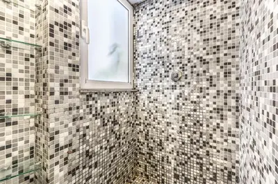 a bathroom with a shower with a window at Casa Ghetto 13 in Rome