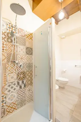 a bathroom with a shower and a toilet at The Central View - DolceVite in Rome