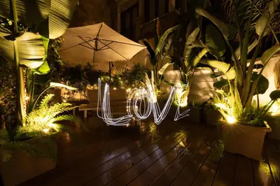a sign that says love written in lights at The Central View - DolceVite in Rome