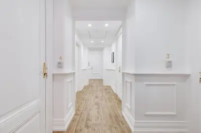 a hallway with white walls and a wooden floor at Monti Suites Cavour in Rome