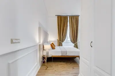 a bedroom with a bed and a window at Monti Suites Cavour in Rome