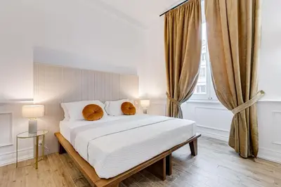 a bedroom with a bed with two pillows on it at Monti Suites Cavour in Rome