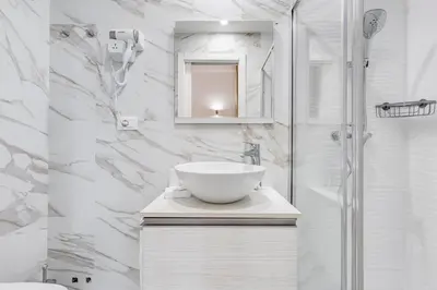 a white bathroom with a sink and a shower at Monti Suites Cavour in Rome