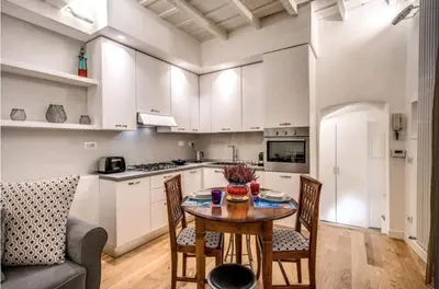 a living room with a gray couch in a kitchen at suity I cozy leutari 23 in Rome